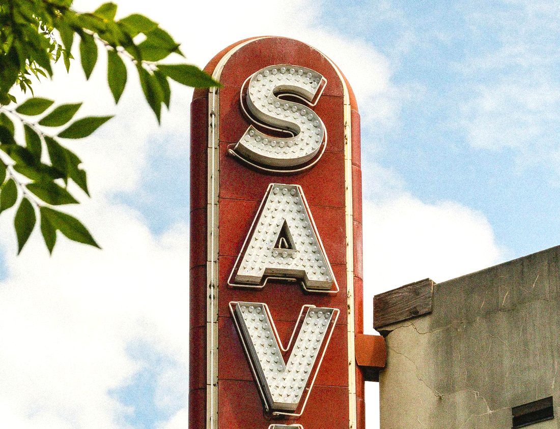 The Savannah Theatre's vertical sign against a blue sky
